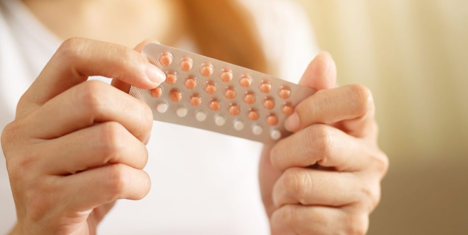 Woman hands opening birth control pills in hand. eating Contraceptive pill. Contraception reduces childbirth and pregnancy concept. Woman hands opening birth control pills in hand. eating Contraceptive pill. Contraception reduces childbirth and pregnancy concept.